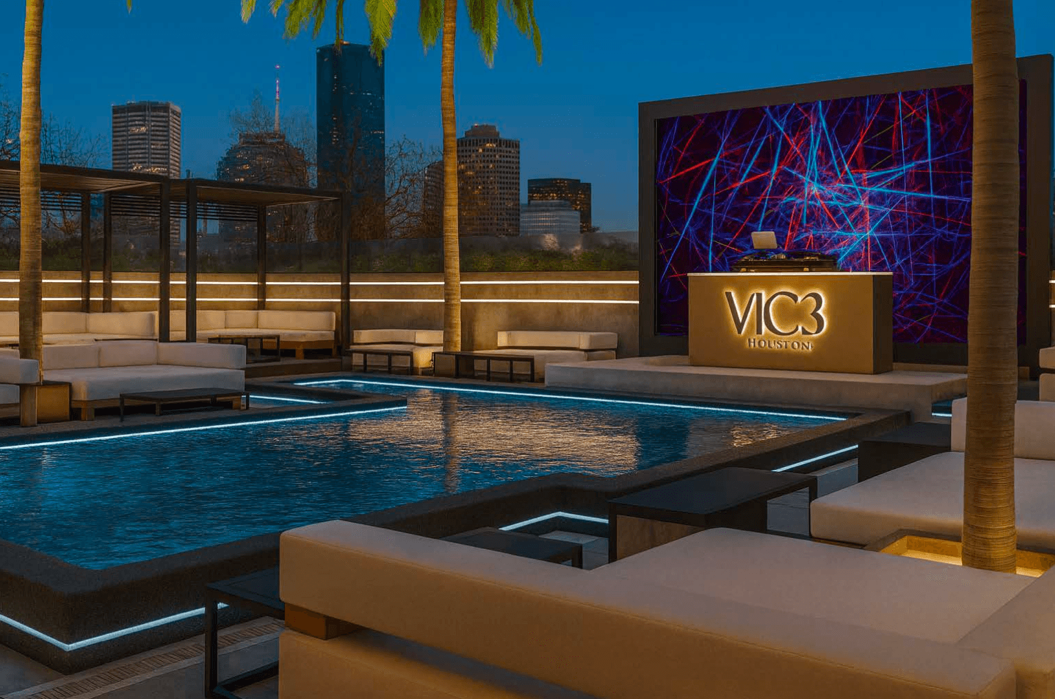 VIC3 Houston rooftop pool with LED lighting and Houston skyline